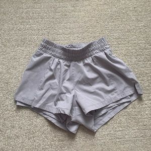 Tan colored athletic shorts with built in spandex